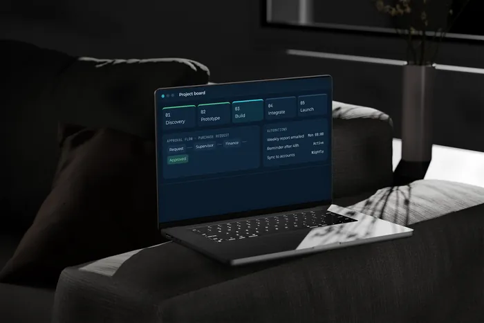 A laptop showing a project board and automations with sample data.