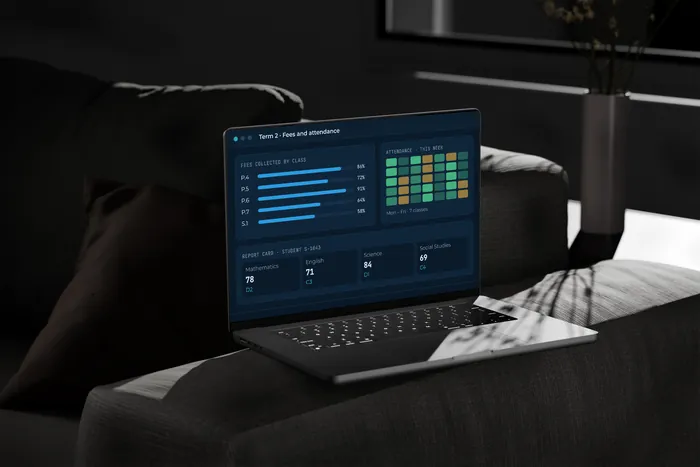 A laptop showing school fees and attendance with sample data.